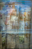 Self-portrait layered with city reflections in glass windows.