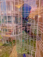 Photomontage self-portrait layered with modern glass architecture.