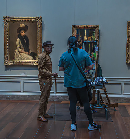 A visitor at the National Gallery observes an artist replicating a classical portrait, connecting the past and present through art.