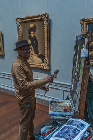 An artist in the National Gallery working on a painting, with classical art pieces in the background, highlighting the tradition of live artistry.