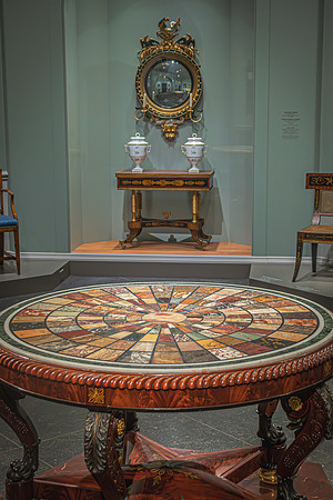 An ornate table with intricate wood inlays, part of the National Gallery's furniture collection, exhibits fine craftsmanship.