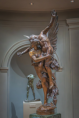 A dynamic bronze sculpture of a winged figure capturing a moment of triumph, displayed within the National Gallery.