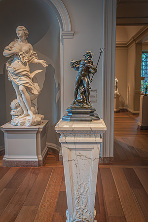 Marble and bronze sculptures in contrasting poses on display at the National Gallery, offering a study in form and material.